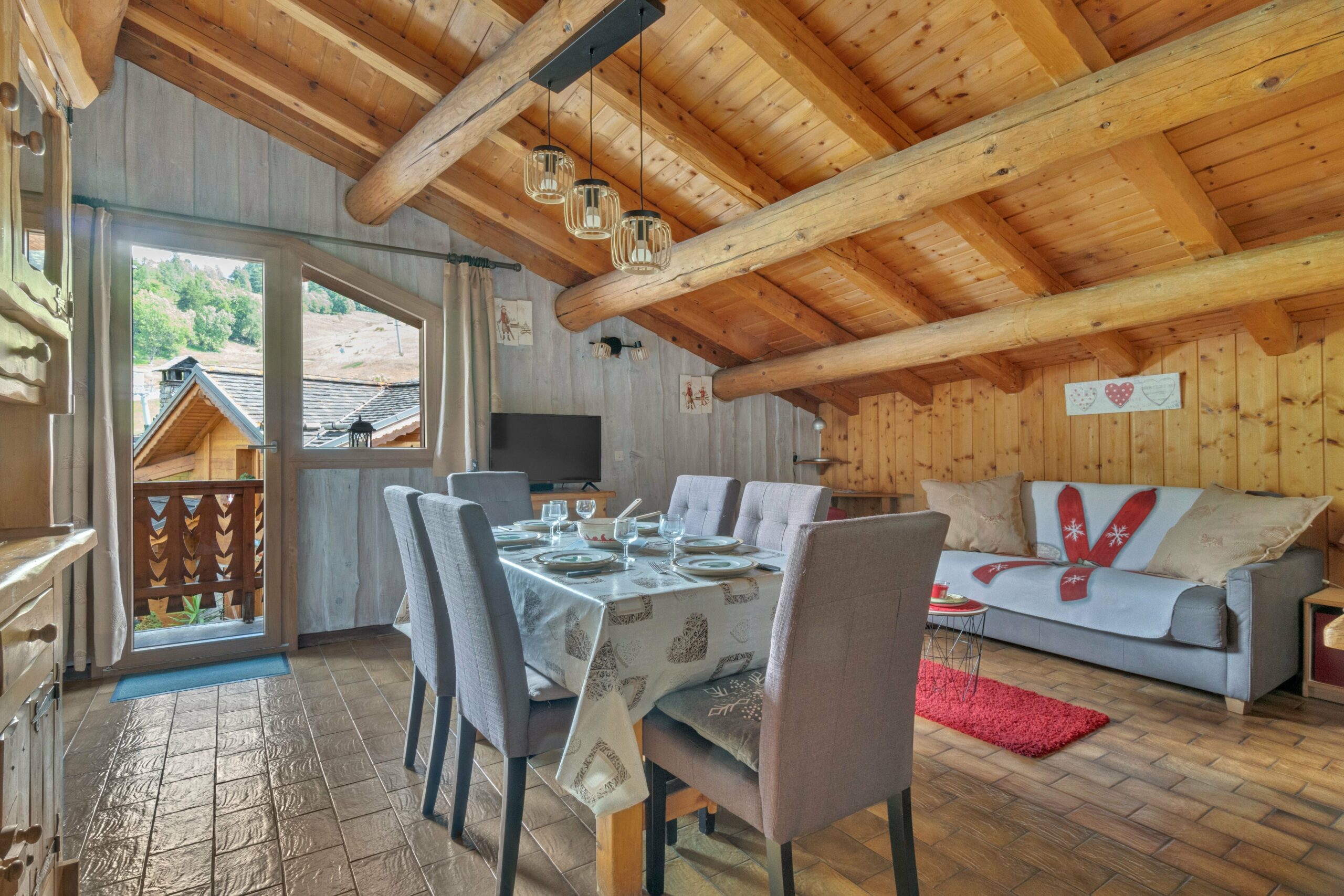 Salon/salle à manger avec cachet savoyard, balcon plein sud, vue en hauteur sur le village